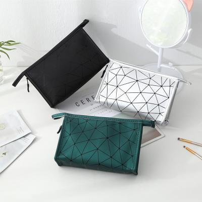 China Normcore/2020New Minimalist rhombus popular geometric portable travel storage bag PULeather diamond waterproof wash bag cosmetic bag PULeather waterproof bag for sale