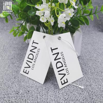 China Sustainable Custom Logo Recycled Kraft Paper Thick Hot Silver Printed Hang Tag For Apparel for sale