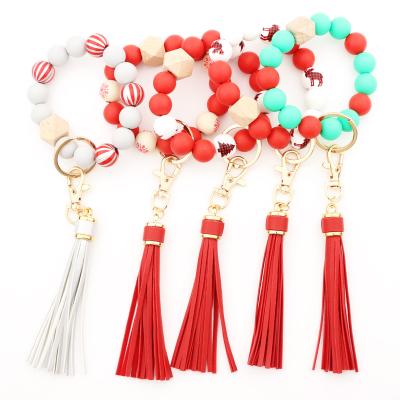 China New Christmas Gift Promotion Gift Silicone Beads Wooden Tassel Bracelet Key Chain Decorations for sale