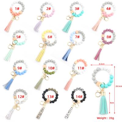 China 2021 Hot Selling Logo Silicone Wooden Beads Leather Tassel Leather Key Chain Custom Wristband Bracelets for sale