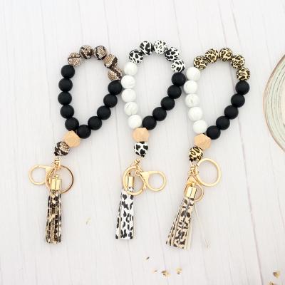 China 2021 Hot Selling Logo Silicone Wooden Beads Leather Metal Key Chain Tassel Custom Bangle Bracelets for sale