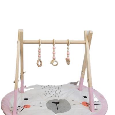 China Non-Toxic Newborn Gift Foldable Wooden Baby Play Gym Toys with Hanging Sensory Teething Toys Teethers for sale