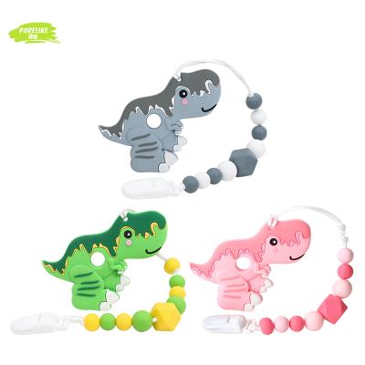 China Custom Safety Hot Selling Baby Gift Set Beads Teether Toy Pacifier Holder Dinosaur Silicone Clip for sale