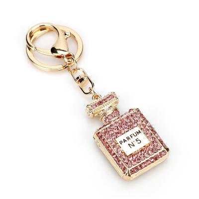 China Casual Famous Brand Luxury Rhinestone Full Crystal Perfume Bottle Key Chain For Women for sale