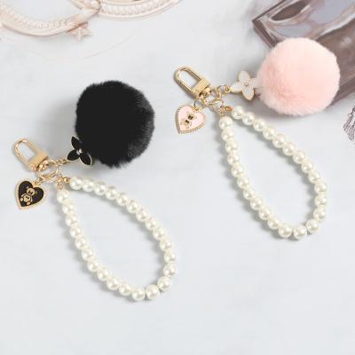 China 2022 New Fashion Casual Pearl Key Chain For Car Women Handbag Key Ring Fluffy Puff Ball Keychains for sale