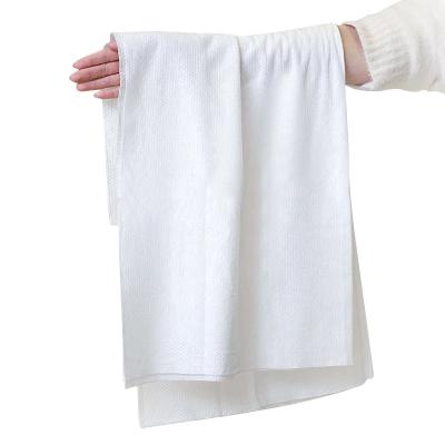 China Spunlace Towel Nonwoven Disposable Bath Towel Thicken Soft Intake Travel Portable Hotel Shower Disposable Towel for sale