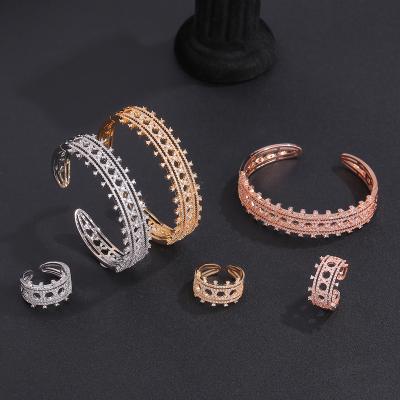 China FASHIONABLE Arabic Style Shrapnel Design Open Bracelet and Ring 2 Pcs Set Cavity Zirconium Copper Inlaid Luxury Bracelet Ring Jewelry Set for sale