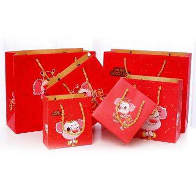 China Wholesale Customized Recyclable New Year Cartoon Cute Pig Gift Packaging Red Paper Bag for sale