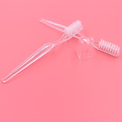 China Foldable Handle 26 Tufts Transparent Bristles PS Or PP Hotel Toothbrush for sale