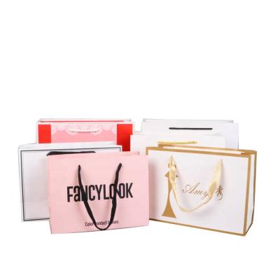 China Recyclable White Cardboard Kraft Paper Bag Printing Logo Cosmetics Advertising Gift Portable Paper Bag for sale