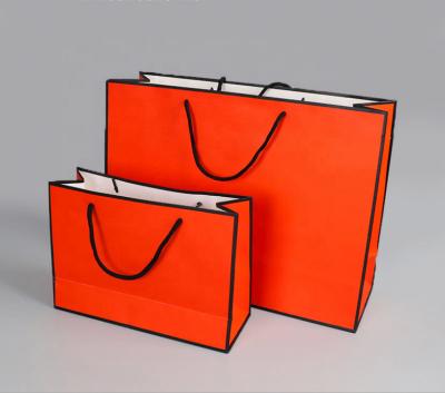 China Disposable Retail Cheap Red Paper Shopping Bag With Ribbon Strap for sale