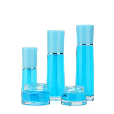 China Push Button Essential Oil Cosmetic Bottle Customize Pump Bottle Clear Cosmetic Glass Kit for sale