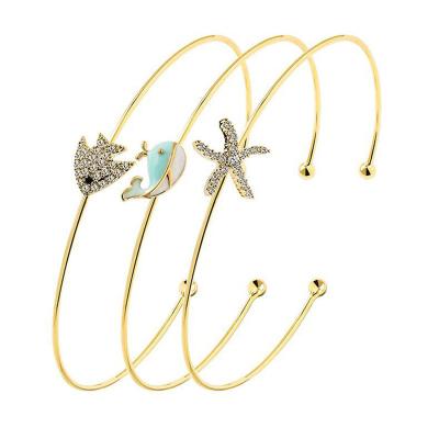 China Non Allergic Fashion Gold Plated Cute Starfish Dolphin Fish Charm Set Open Cuff Bracelet 3 Adjustable Bracelet For Girls Ladies for sale