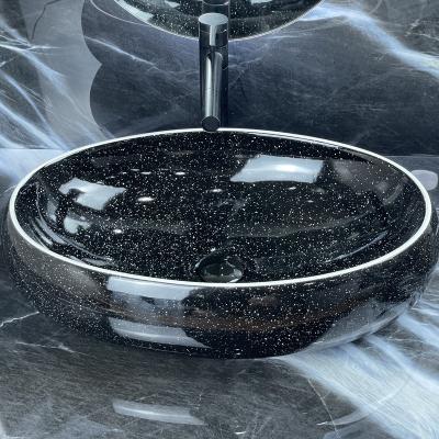 China Easy Clean Ceramic Black And White Oval Bathroom Sink Hand Wash Basin Shape Countertop Bowl Sink for sale