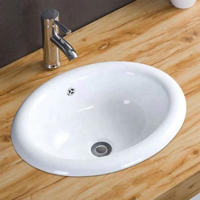 China Easy Clean Ceramic Bathroom Vanity Oval Basin Undermount Sinks With Overflow Hole for sale