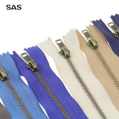 China Automatic Lock SAS Zipper Offer End Open End Customized Logo Color Brass Teeth Metal Zipper For Clothes for sale