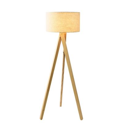 China Nordic three-legged modern sofa wood red Japanese creative bedside living room bedroom net wind floor lamp Nordic three-legged table lamp for sale