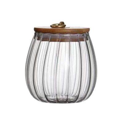 China Borosilicate Glass Stocked Storage Vessel With Lid Natural Wood Ribbed Clear Glass Storage Canister Jar for sale