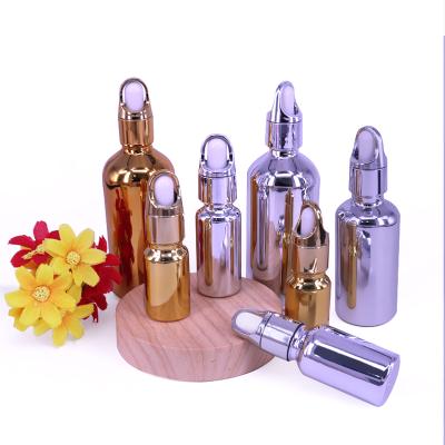 China Gold Oil Bottle 20ml 30ml 50ml Small Gold Bottle Eco-friendly Recyclable Plated Essential Cosmetics Bottle for sale