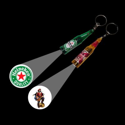 China Holiday decoration & Factory Price Gift AG3 Projector Battery Beer Key Chain Mini LED Key Chain Projection Flashlight For Promotional Advertising Gifts for sale