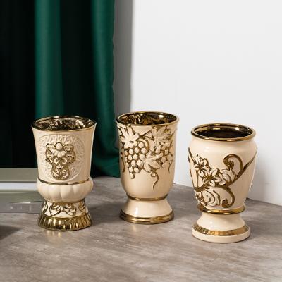 China Modern Interior Decorations Gold tabletop ceramic decoration wedding centerpiece porcelain vase embossed luxury ceramic flower vases for home decor for sale