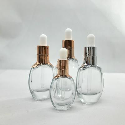 China Personal Care 15ml 30ml Luxury Pink Face Cap Serum Cosmetic Packaging Gold Dropper Glass Bottle for sale