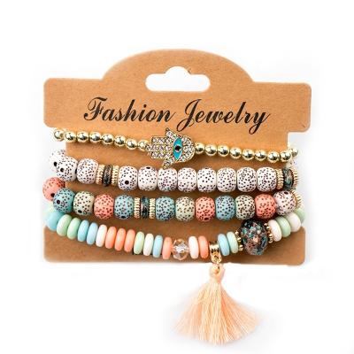 China TRENDY personalized boho handmade jewelry sets 4pcs acrylic gold plated evil eye palm tassel charm beaded bracelet set women for sale