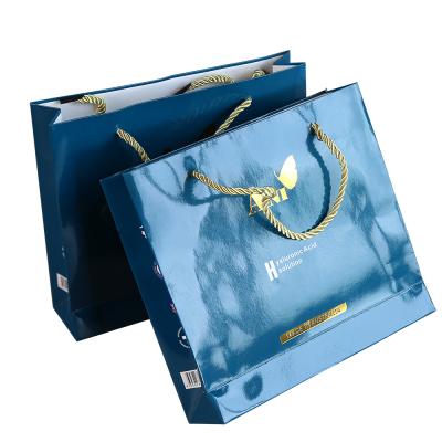 China Recyclable Gold Logo Hot Foiled Stamping Glossy Shinny Paper Bag with Cotton Rope Handles for Shoes for sale