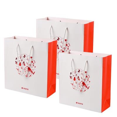 China Recyclable Custom Luxury Apparel Orange Gift Packaging Retail Shopping Paper Bags With Handles For Clothes for sale