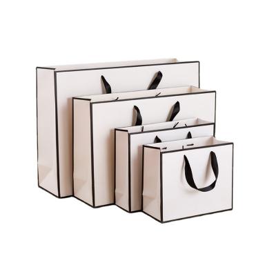 China Recyclable Wholesale Custom Printed White With Black Cardboard Gift Apparel Shopping Stock Paper Bag With Your Own Ribbon Handle Logo for sale