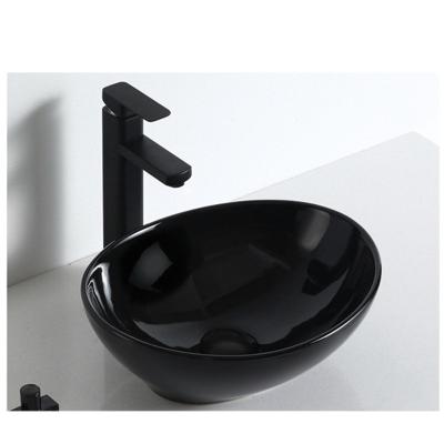 China Chaozhou factory black washroom modern unique ceramic small size water basin countertop oval art basin for sale