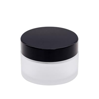 China 15 20 30g Round Logo Printing Cosmetic Clear Frosted Glass Jar With Black Plastic Lid For Body Cream for sale