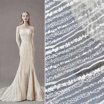 China Handmade white luxury sequins beaded bridal lace fabric with sequins for women wedding bridal dress for sale