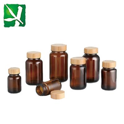 China Eco - Friendly Brown Glass Medicine Bottle With Screw Bamboo Lip Sustainable Packaging Options for sale