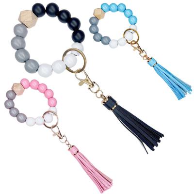 China Sood GC220408 Polyester Beads Circle Tassel Keychain Elastic Key Chain Bracelet Natural Wood Keychains Elastic Pendant Bracelet for sale