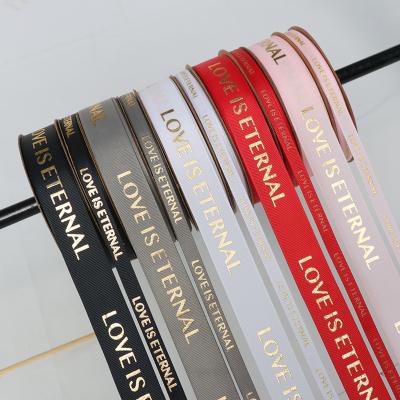 China Hot Selling Grosgrain 50 Yards Polyester Custom Gift 2.5cm Ribbon Printed Logo Gold Foil Letters Satin Ribbon For Flower Wrapping for sale