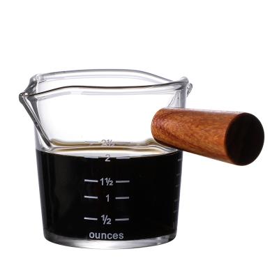 China Espresso 70/75Ml Clear Scale Measuring Cup Double Mouth Viable Heat Resistant Glass Milk Jug With Wooden Handle for sale