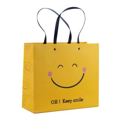 China Recyclable Custom Logo Kraft Christmas Promotion Birthday Gift Wrapping Paper Yellow Paper Bag for sale