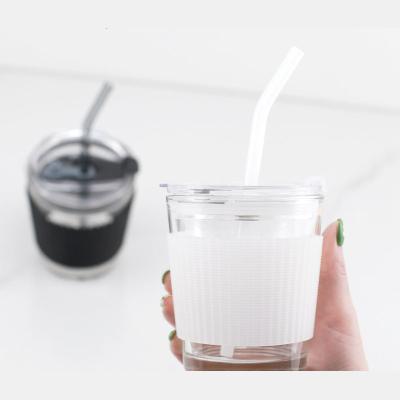 China Sustainable Glass Drink Mug With Straw Lid And Clear Silicone Sleeve Glass Coffee Mugs for sale