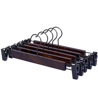 China Durable Wooden Clip Hangers Retro Black Wooden Pants Hanger With Clip For Garment Shops for sale