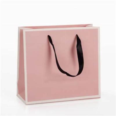 China Recycled materials wholesale new design handle gift bag customized luxury paper shopping bag for sale