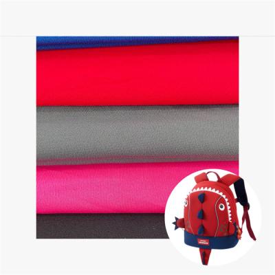 China Tricot Polyester Jersey Tejido impermeable Retardante de llamas para ropa deportiva en venta