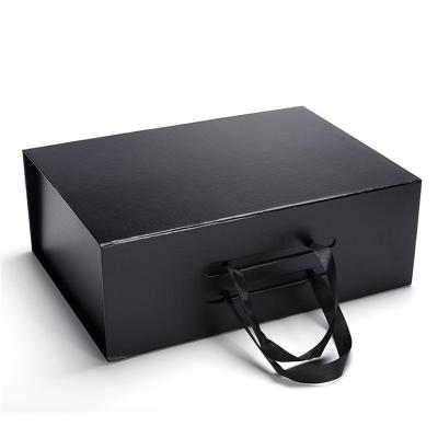 China Custom Recyclable Matte Black Folding Paper Magnetic Ribbon Logo Printed Black Folding Packaging Gift Boxes for sale