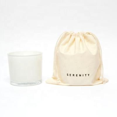 China Scented white glass jar scented wick candle in fabric bag for sale