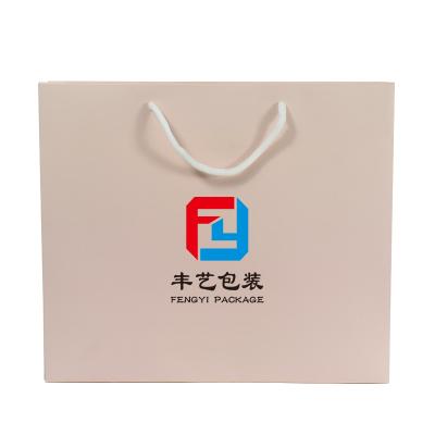 China Handmade Luxury Apparel Packaging Pink Kraft Paper Shopping Bag For Clothes for sale