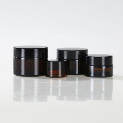 China UV Stocked Dark Brown Black Glass Jars with 100ml Capacity for sale