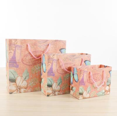 China Custom Recyclable Unique Design Paper Bag Panel Butterfly Printing Gift Bag Rope Handle Direct Selling Cheap Price With Ribbon Handle for sale