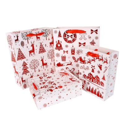 China Customized Recyclable Size Christmas Design Art Paper Gift Bag Red Foil Printing Gift Bag Hot Stamping With Ribbon Handle for sale