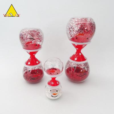 China Europe Santa design fancy sand glass timer with red glitter inside for sale