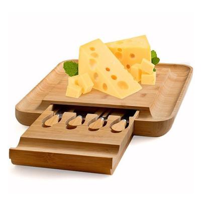 China Sustainable Bamboo Cheese Cutting Board with 4 Stainless Steel Magnetic Knives Charcuterie Serving Tray Set for sale